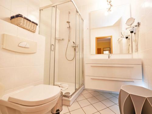 a bathroom with a shower and a toilet and a sink at Wohnpark Stadt Hamburg - Apt. 15 in Binz