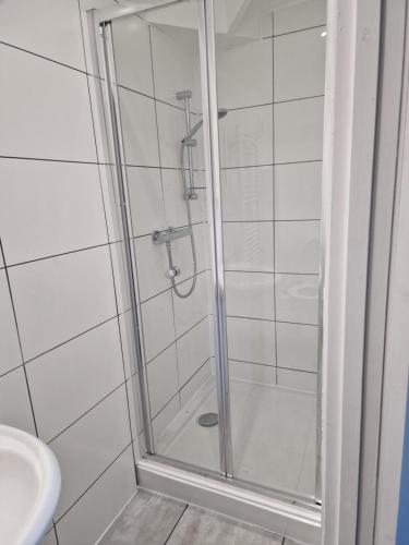 a shower with a glass door in a bathroom at Spectacular Period Property Located In Leicester in Leicester