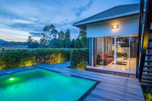 a swimming pool in the backyard of a house at The Haven Krabi in Ao Nang Beach