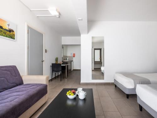 a living room with a couch and a table at Rio Gardens Aparthotel in Ayia Napa
