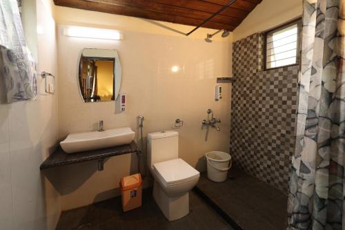 a bathroom with a toilet and a sink at Avadale Coorg - Stag Groups Not Allowed in Ammatti