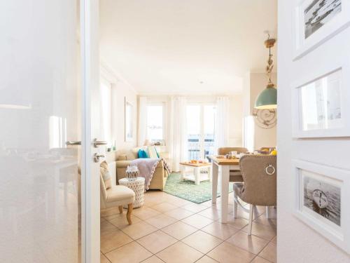 a living room with a table and a dining room at Wohnpark Stadt Hamburg - Apt. 30 in Binz