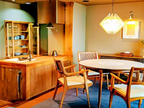 a kitchen with a table and chairs and a sink at Hakone Villa Bizan in Hakone