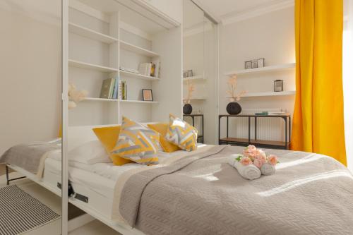 a bedroom with a bed with two stuffed animals on it at Lakeview Apartment Kapelanów Armii Krajowej by Renters in Warsaw