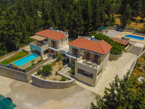 an aerial view of a house with a swimming pool at Sea View Three Bedroom Villa Giorgios in Gavalochori