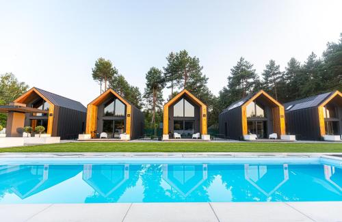 a house with a swimming pool in front of it at Natura Park Radawa in Radawa