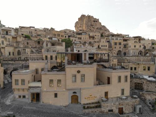 a group of buildings on top of a mountain at Kappadoks Cave Hotel in Uchisar