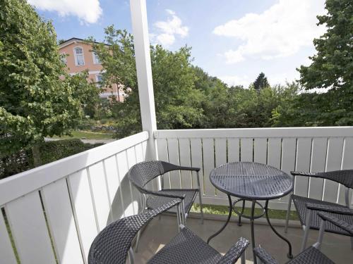 a patio with chairs and a table on a balcony at Wohnpark Stadt Hamburg - Apt. 37 in Binz