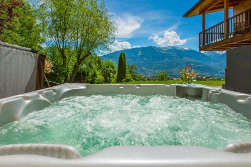 a jacuzzi tub with a view of a mountain at Panoram'Alp in Savièse