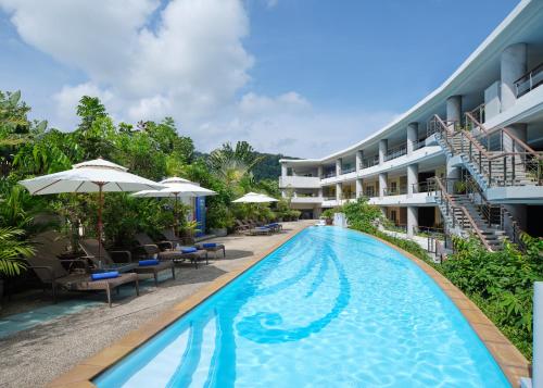 a swimming pool in front of a hotel at Homm Bliss Southbeach Patong in Patong Beach