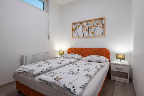a bedroom with a bed and a picture on the wall at Nika & Erik in Kranjska Gora