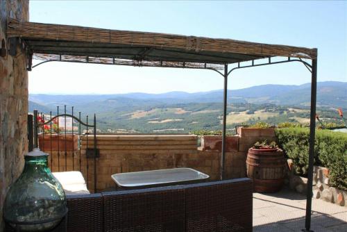 an outdoor kitchen with a view of the mountains at Tuscan Farmhouse with 7 Apartments for max 30 persons in Montecastelli Pisano