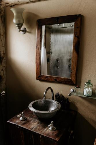 a bathroom with a sink and a mirror on a counter at Tarangire Treetops in Kwa Kuchinia