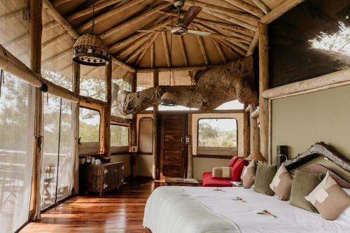 a bedroom with a large bed in a house at Tarangire Treetops in Kwa Kuchinia