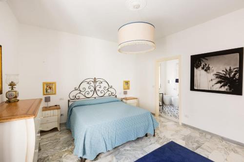 a white bedroom with a bed and a bathroom at B&B Casa Sabella in Lecce