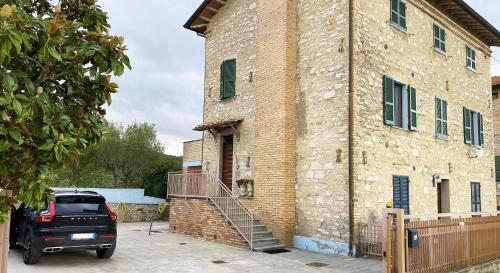 a car parked in front of a brick building at AlbaUmbra in Umbertide