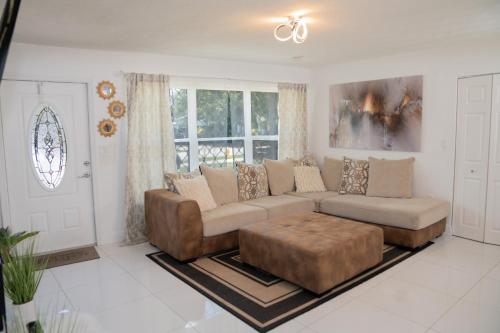 a living room with a couch and a coffee table at Light & Cozy House in Pompano Beach - BBQ, Patio, Parking in Pompano Beach