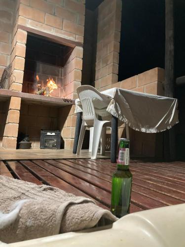 a patio with a fireplace and a table and a bottle at The love bubble in Lutzville