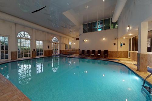a large swimming pool in a large room at Village Hotel Chester St David's in Garden City
