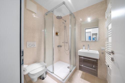 a bathroom with a shower and a toilet and a sink at Montreux Grand Rue - Swiss Hotel Apartments in Montreux