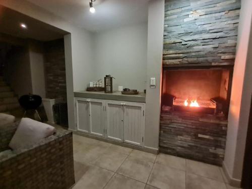 a living room with a stone wall and a fireplace at Waves of Mercy in Trafalgar