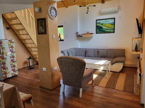 a living room with a couch and a table at Vila Mila Fruška Gora in Velika Remeta