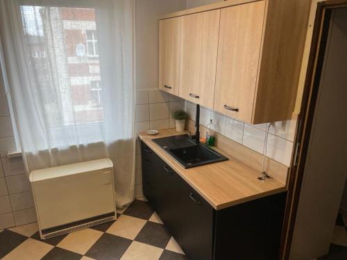 a small kitchen with a sink and a counter at Apartment Chorzow Center in Chorzów