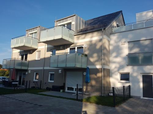 a building with balconies on the side of it at Traumhafte neue Dachterrassenwohnung am Soyener See in Soyen