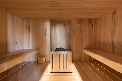 an empty sauna with wooden floors and wooden shelves at Casa Mon in Monforte dʼAlba