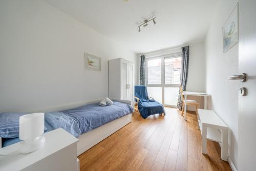 a bedroom with a bed and a desk and a window at Private Rooms in Hannover