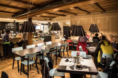 a restaurant with people sitting at tables and a bar at Kreuz Herzogenbuchsee in Herzogenbuchsee