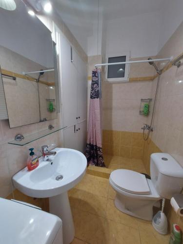 a bathroom with a white sink and a toilet at ADLER 2 Cozy 2 persons apartment downtown Piraeus in Piraeus