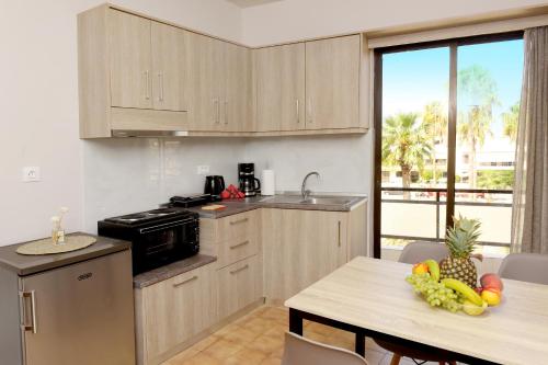 a kitchen with a table with fruit on it at Palm Square Appart in Ialysos