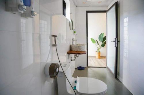 a white bathroom with a toilet and a sink at 5 to 10 bedrooms houses in Ha Long