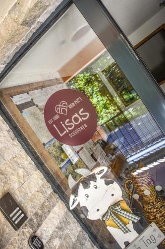 a glass window of a store with a cow on it at Lisas Schröcken in Schröcken