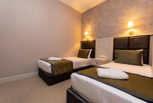 a hotel room with two beds in a room at CONNECT THERMAL HOTEL in Ankara