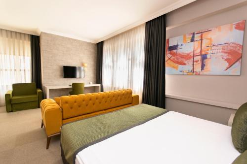 a hotel room with a bed and a chair at CONNECT THERMAL HOTEL in Ankara