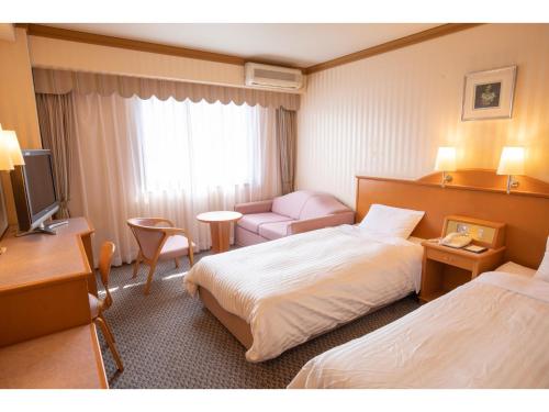 En eller flere senge i et værelse på Hotel Castle Inn Ise Meotoiwa