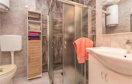 een badkamer met een douche, een wastafel en een toilet bij 3 Bedroom Amazing Apartment In Banjevci in Banjevci