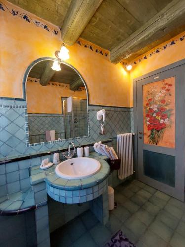 a bathroom with a sink and a mirror at AL CASALE SANT' ANNA PELAGO in SantʼAnna Pelago