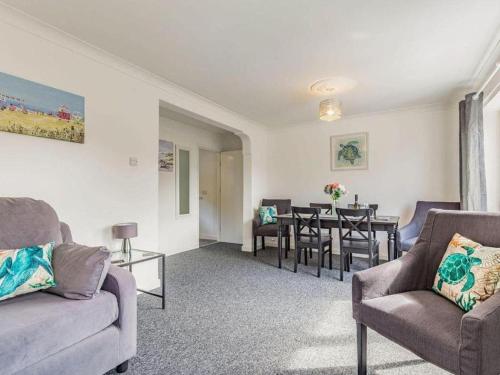 a living room with a couch and chairs and a table at Lovely Magnolia Apartment 2 King-sized 2 single beds in Torquay