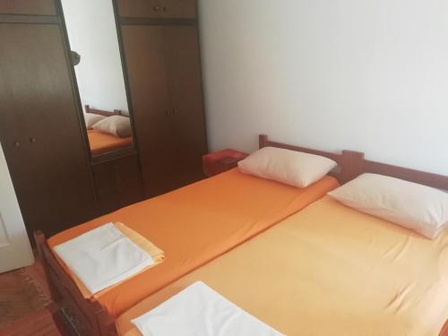 two twin beds in a room with a mirror at Centar Herceg Novi in Herceg-Novi