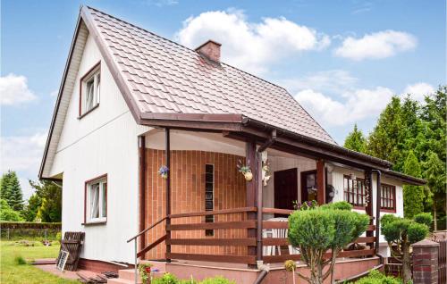 a small white house with a large deck at 2 Bedroom Beautiful Home In Dominikowo in Dominikowo