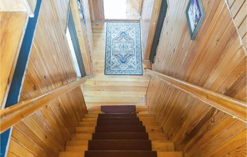 a staircase in a wooden house with a picture on the wall at 2 Bedroom Beautiful Home In Dominikowo in Dominikowo