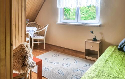1 dormitorio con cama, ventana y mesa en 2 Bedroom Gorgeous Home In Dominikowo, en Dominikowo