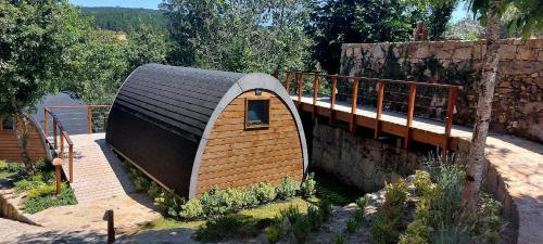 a small house with a roof on a bridge at Green Paradise Glamping in Covas