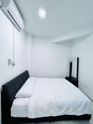 a bedroom with a large white bed in a room at SingBeach holiday house in Mersing