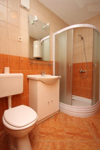 a bathroom with a toilet and a sink and a shower at Family friendly seaside apartments Kustici, Pag - 6376 in Kustići