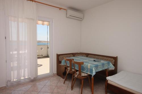 a room with a table and chairs and a window at Apartments with parking space Kustici, Pag - 6287 in Kustići