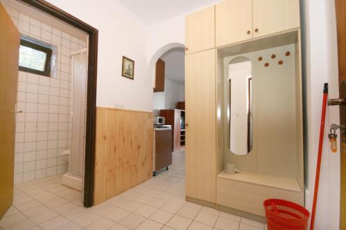 a bathroom with a walk in shower next to a door at Seaside apartments with a swimming pool Potocnica, Pag - 6407 in Borovići